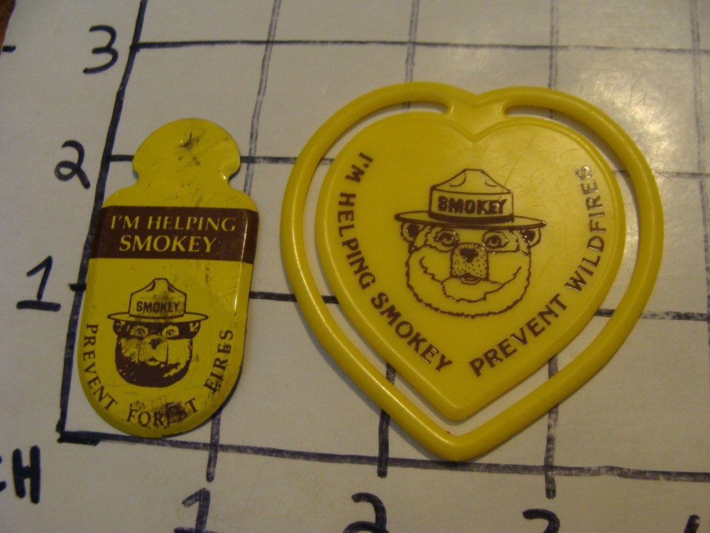 2 smokey the bear items plastic bookmark and metal item as shown